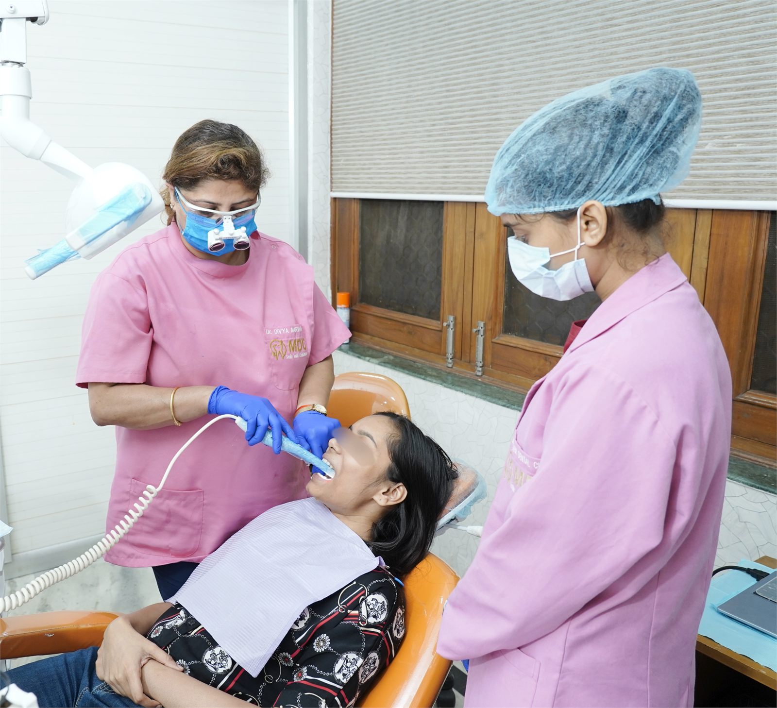 Dr. Divya Marwaha performing dental treatment with an assistant in Gurugram